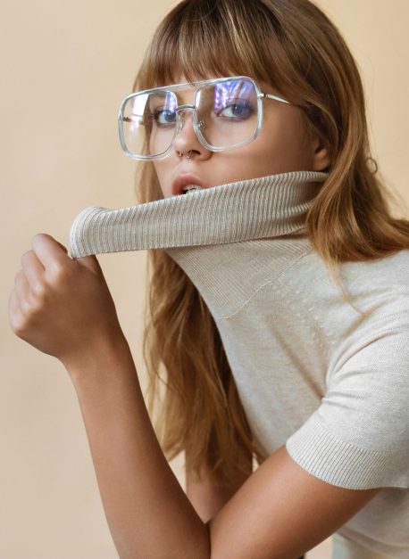 Stylish beautiful fashion girl wear trendy sunglasses looking at camera. Stylish beautiful fashion girl wear trendy sunglasses looking at camera, retro vogue sexy attractive young model woman blond hair in eyewear posing on beige studio background, portrait